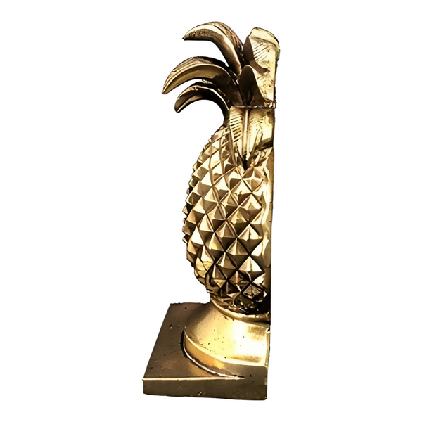 A set of antique gold pineapple shaped bookends with a textured diamond pattern and a square base. Palm Gifts