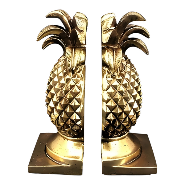 A set of antique gold pineapple shaped bookends with a textured diamond pattern and a square base. Palm Gifts