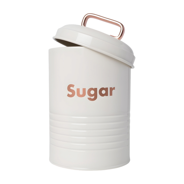 Three white kitchen canisters with rose gold lids, each labelled with a different word: coffee, sugar, and tea. PALM GIFTS