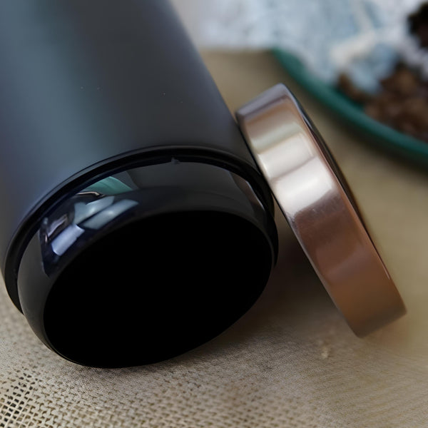 Set of three black metal kitchen canisters with rose gold lids, labelled sugar, tea, and coffee. PALM GIFTS