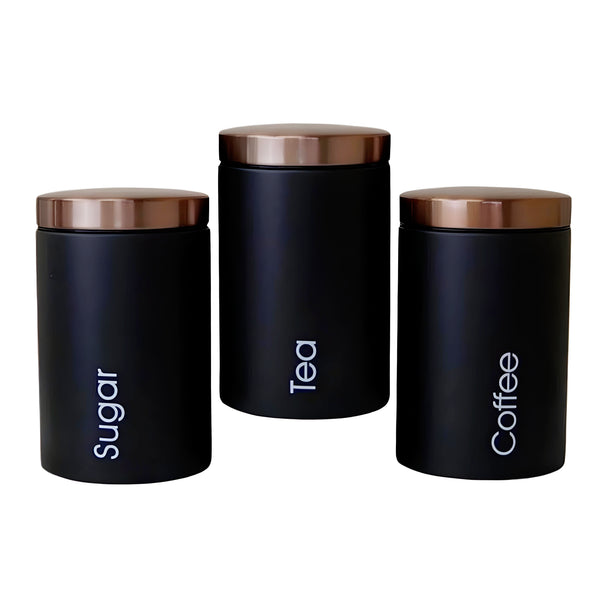 Set of three black metal kitchen canisters with rose gold lids, labelled sugar, tea, and coffee. PALM GIFTS