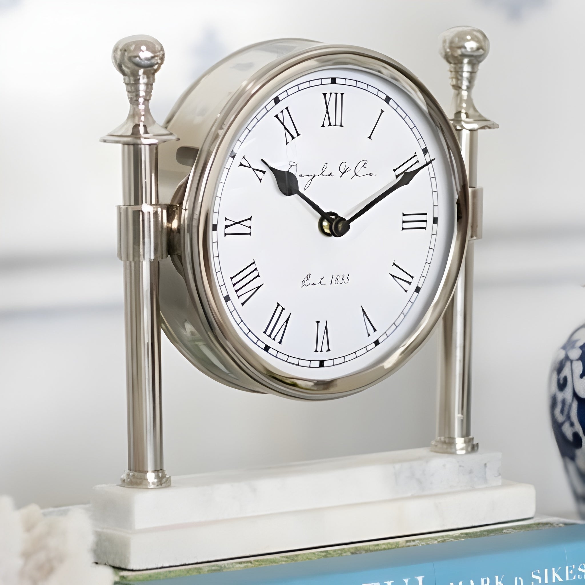 Silver Round Column Mantel Clock On White Marble Base