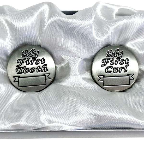 Set of two silver pewter baby keepsakes for first tooth and first curl, presented in a satin gift box. Palm Gifts